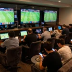 Cakhia users engaging in live sports betting at a stylish lounge, focusing on smartphone apps.